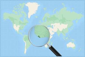 Map of the world with a magnifying glass on a map of Liberia. vector