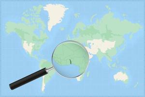 Map of the world with a magnifying glass on a map of Togo. vector