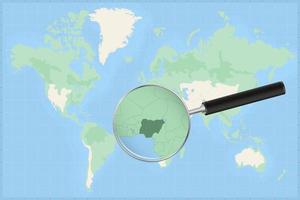 Map of the world with a magnifying glass on a map of Nigeria. vector