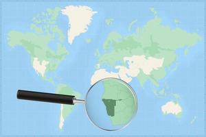 Map of the world with a magnifying glass on a map of Namibia. vector