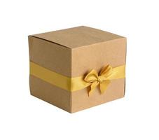 Gift box with gold bow on white background photo