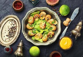 Snails baked with sauce photo