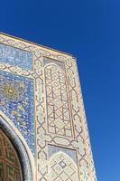 A low-angle shot of the corner of an old traditional building in Central Asia photo