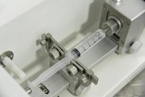 A closeup of the production and testing of medical syringes and droppers photo