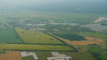 Blick aus dem Flugzeugfenster auf die grünen Wälder und Felder. video