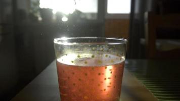 Effervescent tablet in water with bubbles, against influenza, slow motion video