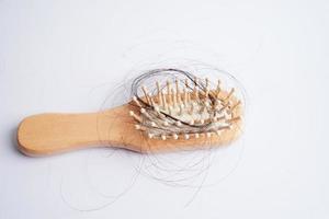 Hair loss fall with comb brush isolated on white background. photo