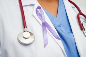 Asian woman doctor with purple ribbon, World Pancreatic Cancer day or World Alzheimer day. photo