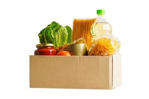 Foodstuffs in donation box isolated on white background with clipping path for volunteer to help people. photo