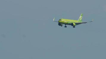 SOCHI, RUSSIA AUGUST 02, 2022 - Commercial airplane Airbus A320 of S7 Airlines landing at Sochi International Airport, side view. Jet passenger plane flies. Tourism and travel concept video