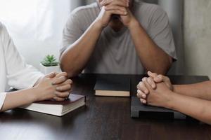 Group of people praying worship believe.  Praying and praise together at home. devotional or prayer meeting concept. photo