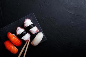 japanese sushi food. Maki ands rolls with tuna, salmon, shrimp, crab and avocado. Top view of assorted sushi. photo