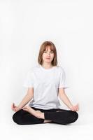 Girl meditating white background photo