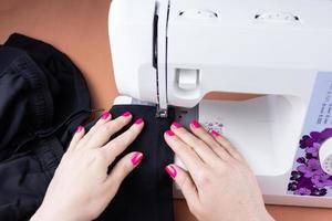 Hands on the sewing machine photo