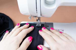 Hands on the sewing machine photo