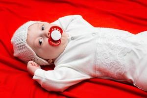 baby on a red cloth photo