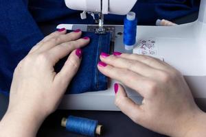 Hands on the sewing machine photo