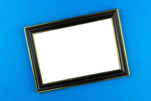 Wooden frame blue background photo