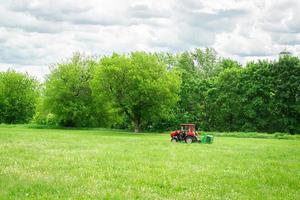 tractor lawn mower mows grass photo