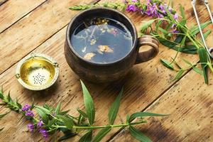 Healing fireweed tea,rustic wooden table photo