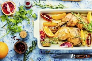 Baked chicken legs with oranges photo