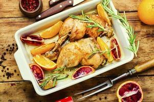 Baked chicken legs with oranges photo