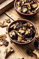 Sliced dried mushrooms,wooden table photo
