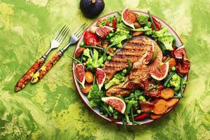 Trout steak fried with vegetables,top view photo