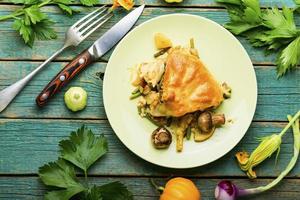 Homemade pie with zucchini and mushroom,wooden table photo