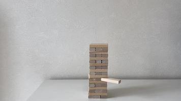 Jenga game and cat. In the video, the cat destroys the tower of wooden cubes. video