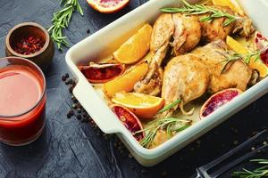 Roasted chicken legs with oranges photo