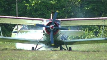 AN 2 aircraft stands at the airport before takeoff and the engine warms video