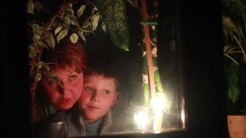 Mom and son illuminated by candlelight video