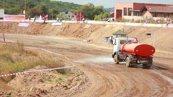 watering machine pours dirt road video