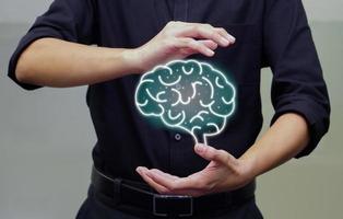 Man holding digital of human brain in his hand. Artificial intelligence and holographic concept. photo