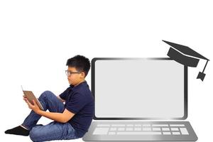 Young boy sitting read a book and leaning against virtual shiny computer or laptop. Education and learning concept. photo