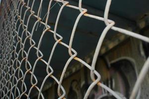 Rusty metal mesh close-up on the background of painted walls. photo