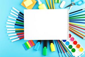 A set of school supplies for learning and creative development on a blue background. photo