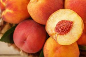 A slice of juicy and ripe peach with a close-up stone. Cut fruit. photo