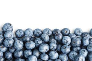 Blueberries are scattered on a white background. Free space, isolate. Studio light. photo