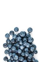 Blueberries are scattered on a white background. Free space, isolate. Studio light. photo