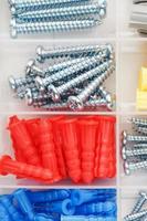 Screws and plastic dowels of various sizes, for repair, construction and installation. photo