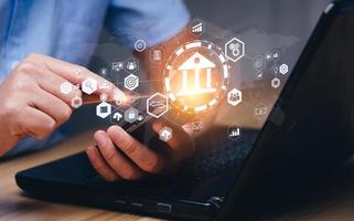 Businessman using online banking on laptop and making payments. Digital marketing.Finance and banking networking.Online shopping and customer network connection icons,Cybersecurity.Business technology photo
