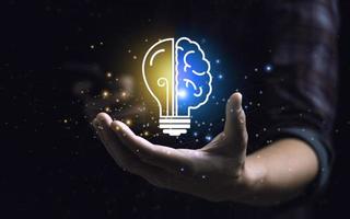 Smart thinking idea and inspiration innovation concept. businessman holding half brain icon and light bulb. Solve problems intelligently photo