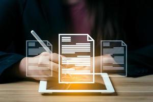 business woman uses a pen to sign electronic documents on digital documents on a virtual screen. electronic signature, Technology and document management photo