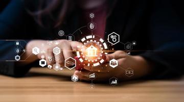 Businessman using mobile online banking and taps a bank icon to connect to a networking. Finance and banking networking. Digital marketing. cyber security. business technology. exchange photo
