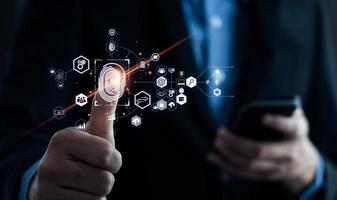 Businessman using fingerprint to access personal financial information, biosecurity. Cybersecurity and hacker protection technology, identity verification photo