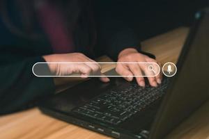 Businessman using laptop to search for information, surfing the Internet network concept information. Businessman hand using laptop to search. Searching Browsing Internet photo