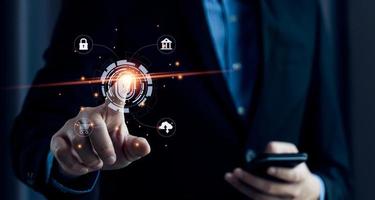 Businessman using fingerprint to access personal financial information, biosecurity. Cybersecurity and hacker protection technology, identity verification photo