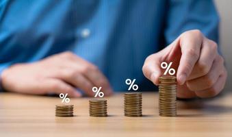 Interest rate and dividend concept. Businessman is calculating income and return on investment as a percentage. Show returns from mutual funds and stocks. long term investment for retirement photo